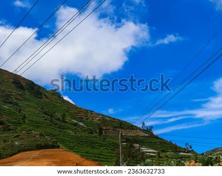 dreamy cloudscape, blue sky clouds on a mountain range