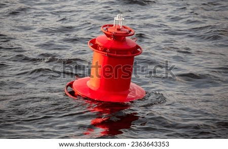The red barrel floats on the river.