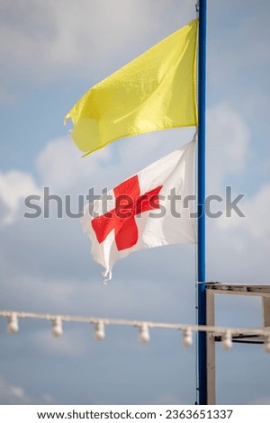 Flags at sea, yellow for swimming and first aid station flag.