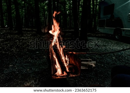 Close up picture of wood burning in a camp fire. Hot Red Flames. Taken in Nova Scotia, Canada Dark Mood