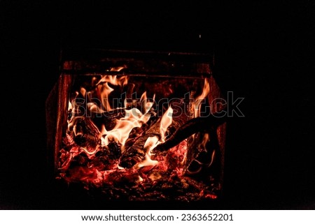 Close up picture of wood burning in a camp fire. Hot Red Flames. Taken in Nova Scotia, Canada Dark Mood