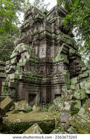Green moss-covered stone building and brick ruins at Ta Prohm Tomb Raider temple complex. Angkor Wat historical site, Siem Reap, Cambodia Royalty-Free Stock Photo #2363673265