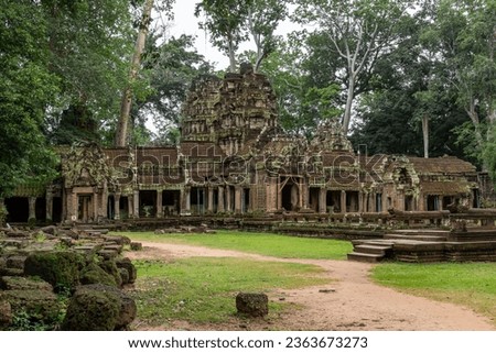 Moss-covered green stone building structure exterior and bricks at Ta Prohm Tomb Raider temple complex in the lush green forest. Angkor Wat historical site, Siem Reap, Cambodia Royalty-Free Stock Photo #2363673273