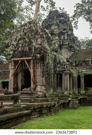 Green moss-covered stone building at Ta Prohm Tomb Raider temple complex. Angkor Wat historical site, Siem Reap, Cambodia Royalty-Free Stock Photo #2363673891