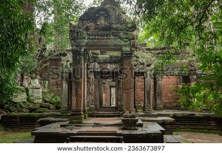 Green moss-covered stone building in the green forest at Ta Prohm Tomb Raider temple complex. Angkor Wat historical site, Siem Reap, Cambodia Royalty-Free Stock Photo #2363673897