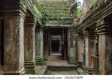 Green moss-covered stone building at Ta Prohm Tomb Raider temple complex. Angkor Wat historical site, Siem Reap, Cambodia Royalty-Free Stock Photo #2363673899