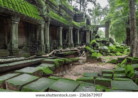 Green moss-covered stone building and bricks at Ta Prohm Tomb Raider temple complex. Angkor Wat historical site, Siem Reap, Cambodia Royalty-Free Stock Photo #2363673907