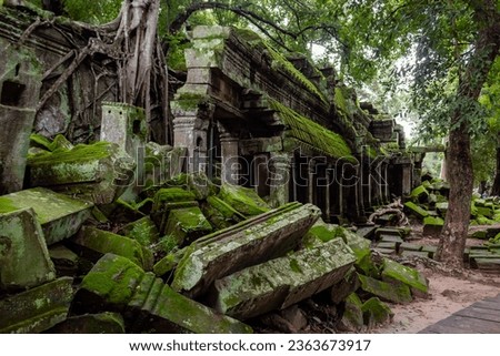 Green moss-covered stone brick building ruins at Ta Prohm Tomb Raider temple complex. Angkor Wat historical site, Siem Reap, Cambodia Royalty-Free Stock Photo #2363673917
