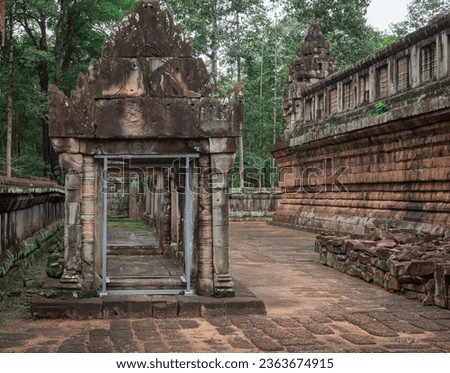 Stone building wall at Ta Prohm Tomb Raider temple. Angkor Wat historical site complex, Siem Reap, Cambodia Royalty-Free Stock Photo #2363674915