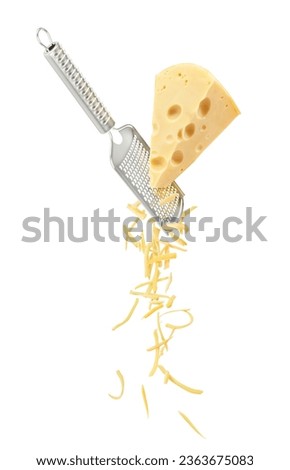 A large piece of cheese is grated and falls down in small pieces isolated on a white background Royalty-Free Stock Photo #2363675083