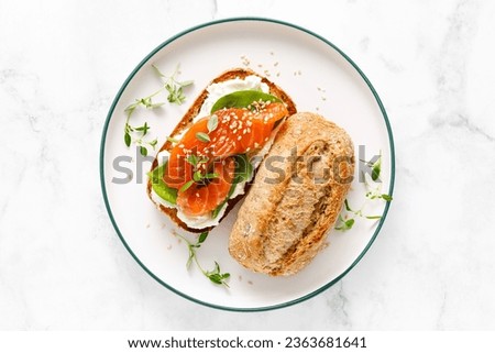 Salmon salted sandwich with spinach and cream cheese, top down view Royalty-Free Stock Photo #2363681641