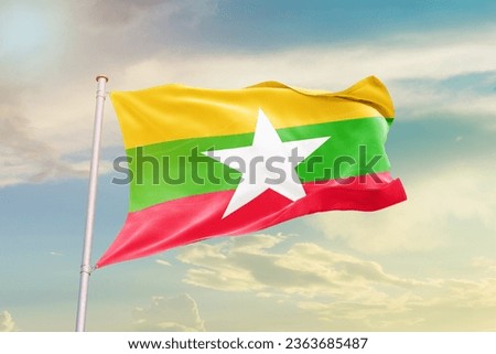 Myanmar  national flag waving in beautiful sky.