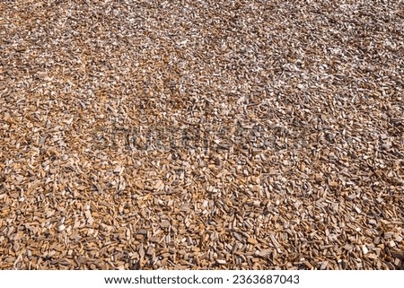 Woodchips used as safe soft surface for a playground or against weeds in a garden, bark mulch Royalty-Free Stock Photo #2363687043