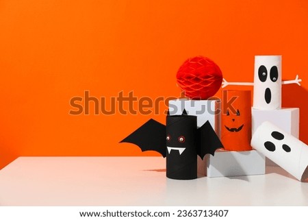 Paper Halloween mockups on orange background, space for text