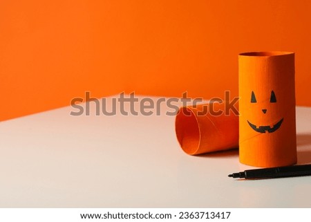 Halloween pumpkin paper mockups on orange background, space for text