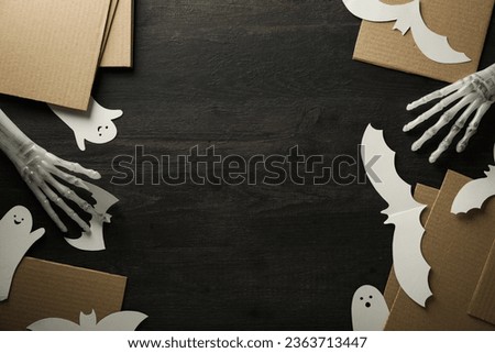 Decorative hands, paper ghosts and bats on wooden background, space for text
