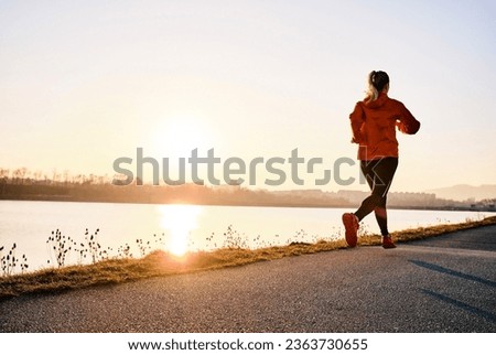 Woman running outdoors. Healthy lifestyle concept, people go in sports. Silhouette family at sunset. Health care, authenticity, sense of balance and calmness.