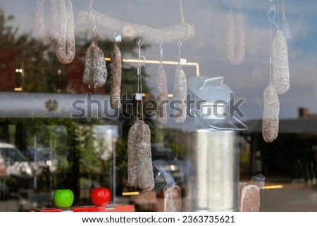 Dry-cured sausages on sale in the window of a delicatessen in Locronan in Brittany.