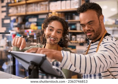 Woman Working In Food Shop Training Man With Down Syndrome How To Use Checkout Royalty-Free Stock Photo #2363746813