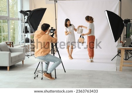 Assistant working with model in photo studio