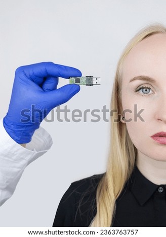 Usb memory stick in head. Flash drive to brain. Girl stands with memory card in her hand and wants to insert it into her body. Cybernetization and rapid learning technologies. Improving your own mind Royalty-Free Stock Photo #2363763757