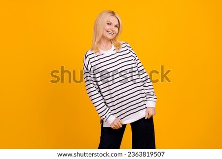 Photo of positive pretty lovely pensioner lady buying new sweater oversize isolated bright color background