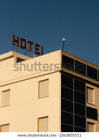 Vintage hotel with solar panels installed on the facade.