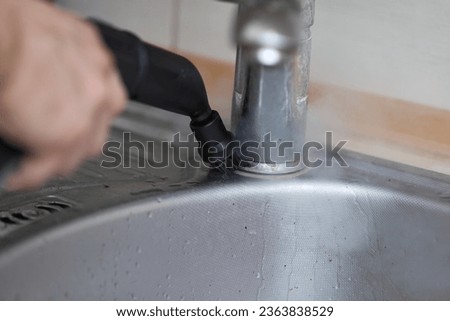 man with professional cleaning steam generator cleaning sink Royalty-Free Stock Photo #2363838529