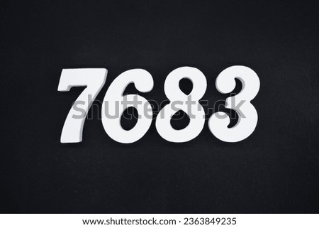 Black for the background. The number 7683 is made of white painted wood.