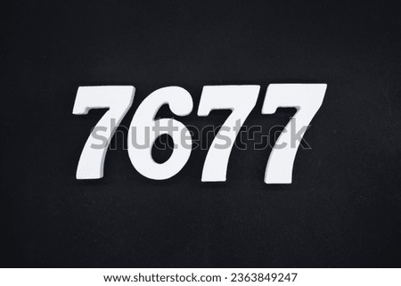 Black for the background. The number 7677 is made of white painted wood.