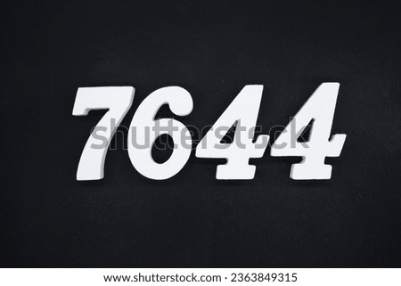 Black for the background. The number 7644 is made of white painted wood.