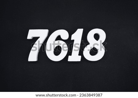 Black for the background. The number 7618 is made of white painted wood.