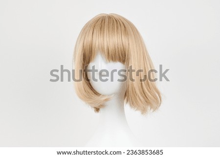 Natural looking blonde fair wig on white mannequin head. Short hair cut on the plastic wig holder isolated on white background, front view
 Royalty-Free Stock Photo #2363853685