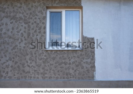 Part of the wall painted with white paint, repair of the facade of the house, Texture of the facade and window of the house