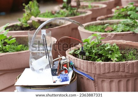 Iot project prototype that waters the plant by sensing the moisture level of the soil using sensor. Using technology to keep the plants healthy Royalty-Free Stock Photo #2363887331