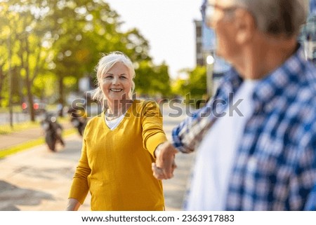 Portrait of happy senior couple standing in city street on a sunny day
 Royalty-Free Stock Photo #2363917883