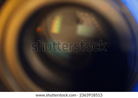 Close up on a photographic front glass with blurred colors.