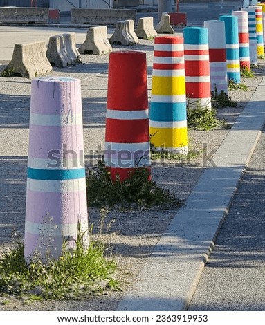 Concrete pillars separating the streets from the sidewalk painted with colorful patterns, Vienna, Austria.