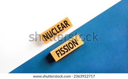 Nuclear fission symbol. Concept words Nuclear fission on beautiful wooden blocks. Beautiful white table white background. Business science nuclear fission concept. Copy space. Royalty-Free Stock Photo #2363922717