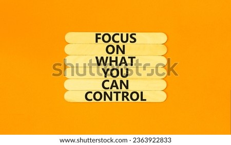 Focus on control symbol. Concept words Focus on what you can control on wooden stick. Beautiful orange table orange background. Business control motivational never stress concept.