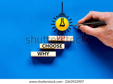 Why choose us symbol. Concept word Why choose us on beautiful wooden block. Businessman hand. Beautiful blue table blue background. Business motivational why choose us concept. Copy space.