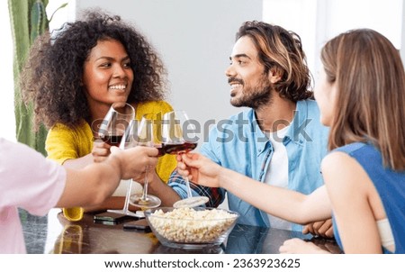 African afro woman, caucasian man wearing casual clothes, smiling with happiness, holding wine glass, toasting for party celebration at home with friends. Lifestyle, New Year, Birthday, Event Concept