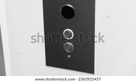 elevator sign and button panel, casting a warm glow in a dimly lit corridor, symbolizing accessibility and vertical movement in modern architecture
