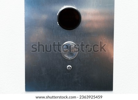 elevator sign and button panel, casting a warm glow in a dimly lit corridor, symbolizing accessibility and vertical movement in modern architecture