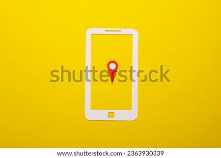 Paper cut smartphone icon with gps navigation point on yellow background