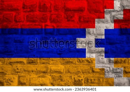 colored national flag Nagorno-Karabakh sovereignty and independence as nation on brick wall, concept unique cultural and political identity, tourism, emigration, economy and politics