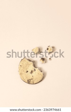The biskvit cookies crumbles on pink background. Creative food concept.