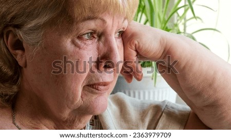 Senior woman crying at home. Pain, disappointment and depression Royalty-Free Stock Photo #2363979709