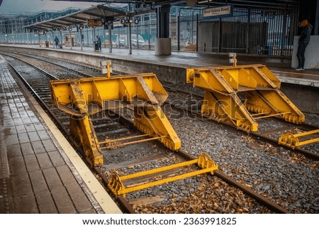 Biffers, dead end or end of track at the Great Victoria street station in Belfast, northern ireland. View towards the train track and covered platform. Royalty-Free Stock Photo #2363991825