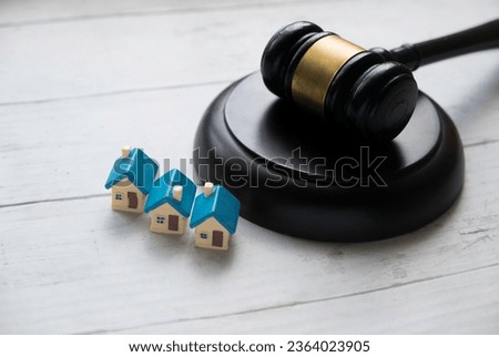Concept of real estate auction, legal system and property division after divorce. Gavel and house key on a wooden background. Royalty-Free Stock Photo #2364023905